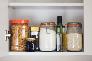 organized cabinet with mason jars and Tupperware 