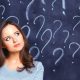 lady standing in front of chalkboard with question marks all over