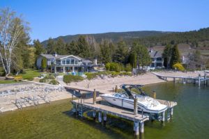 okanagan waterfront property with deck and boat