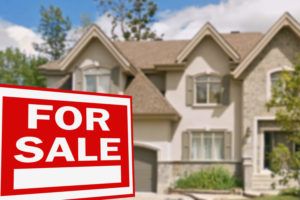 Kelowna home for sale with sign in front lawn